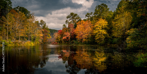 Vibrant autumn foliage reflected in Swartswood Lake at Swartswood Lake State Park, Stillwater, New Jersey