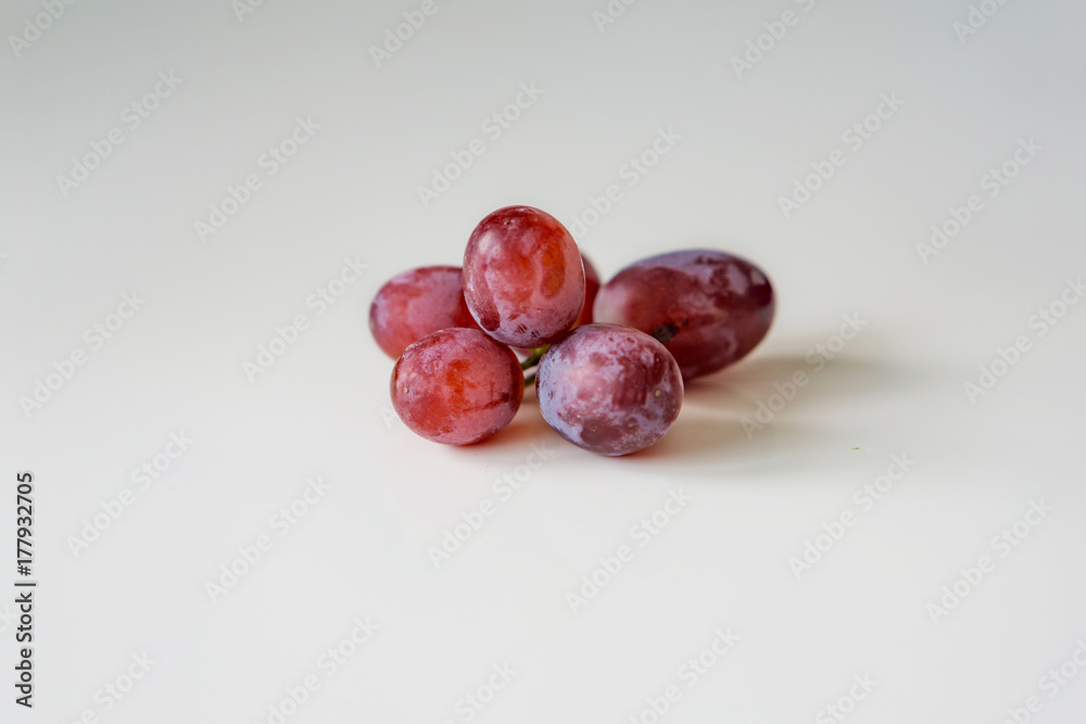 Close-up of grapes on a white background. Dessert grape with a sweet taste, without seeds. Close-up of grapes on a white background. Dessert grape with a sweet taste, without seeds.