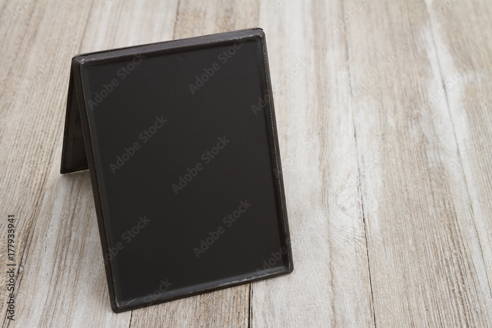 Retro freestanding chalkboard on weathered wood Retro freestanding chalkboard on weathered wood