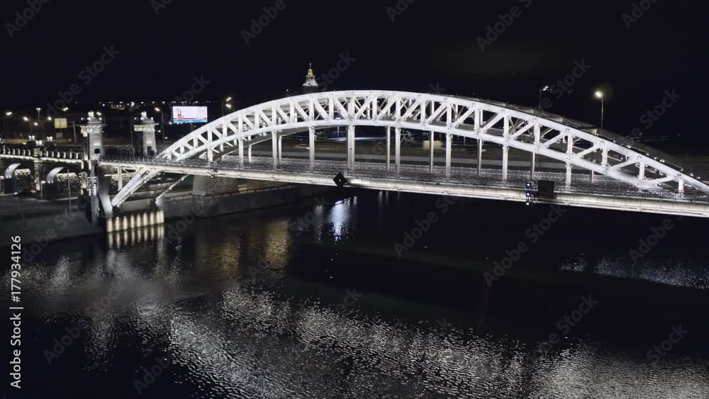 Aerial view of Luzhniki Metro Bridge, also known as Metromost, heavy traffic at night.Moscow river and city skyline during sunset. Big city life concept. Aerial view of Luzhniki Metro Bridge, also known as Metromost, heavy traffic at night.Moscow river and city skyline during sunset. Big city life concept.
