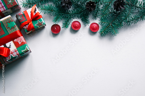 New year's background on a white desk decorated with toys, presents, Christmas tree, candles. Bright colored background symbolizes the new year celebration. Great useful template to wright words down. photo