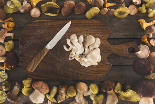 Oyster mushrooms and knife on cutting board