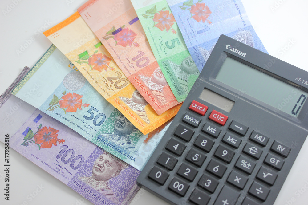 Malaysia bank note ringgit and calculator in white background Malaysia bank note ringgit and calculator in white background