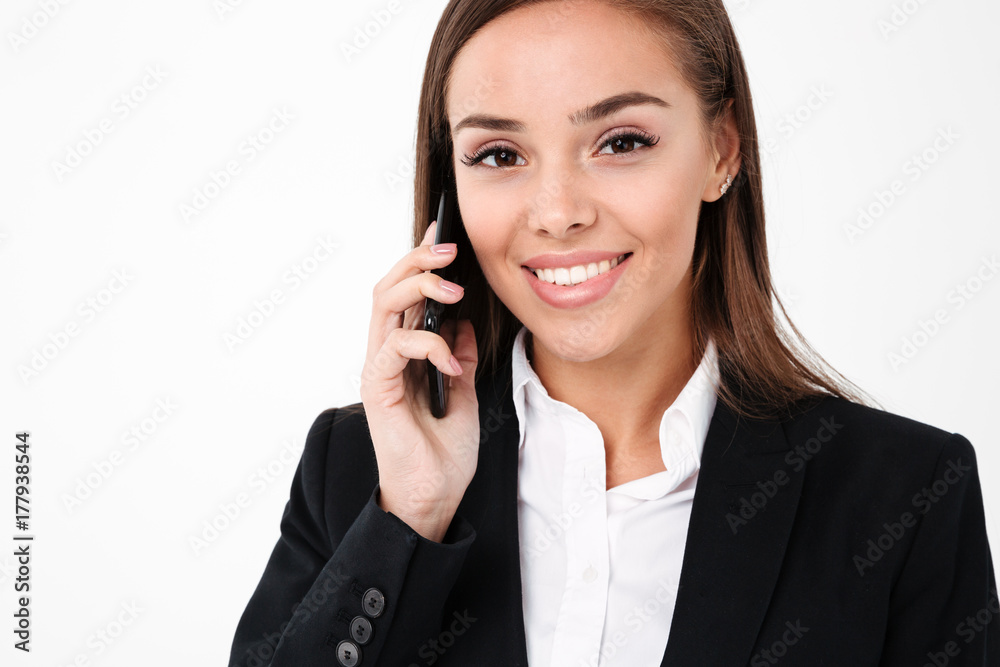 Cheerful pretty businesswoman talking by phone Cheerful pretty businesswoman talking by phone
