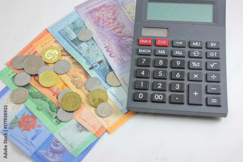 Malaysia bank note ringgit and calculator in white background Malaysia bank note ringgit and calculator in white background