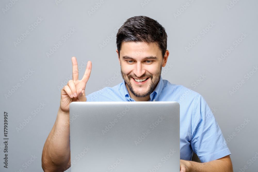 Happy young man video chatting on laptop computer Happy young man video chatting on laptop computer