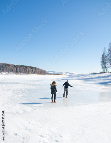 Couple skating on the frozen lake