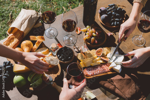 people drinking wine and eating outdoors