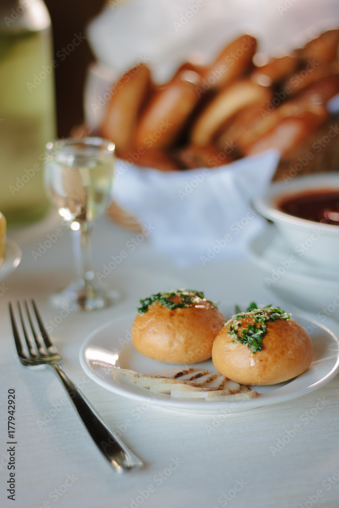 Ukarnian food - round pastries pampushki on ceramic plate.
