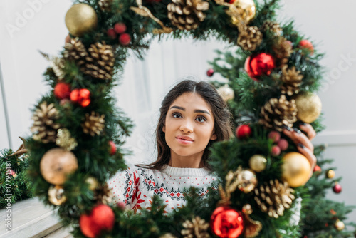 woman holding christmas wreath