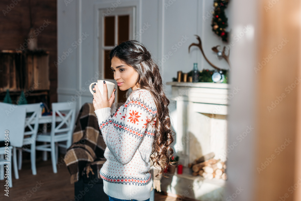 woman enjoying hot drink on christmas