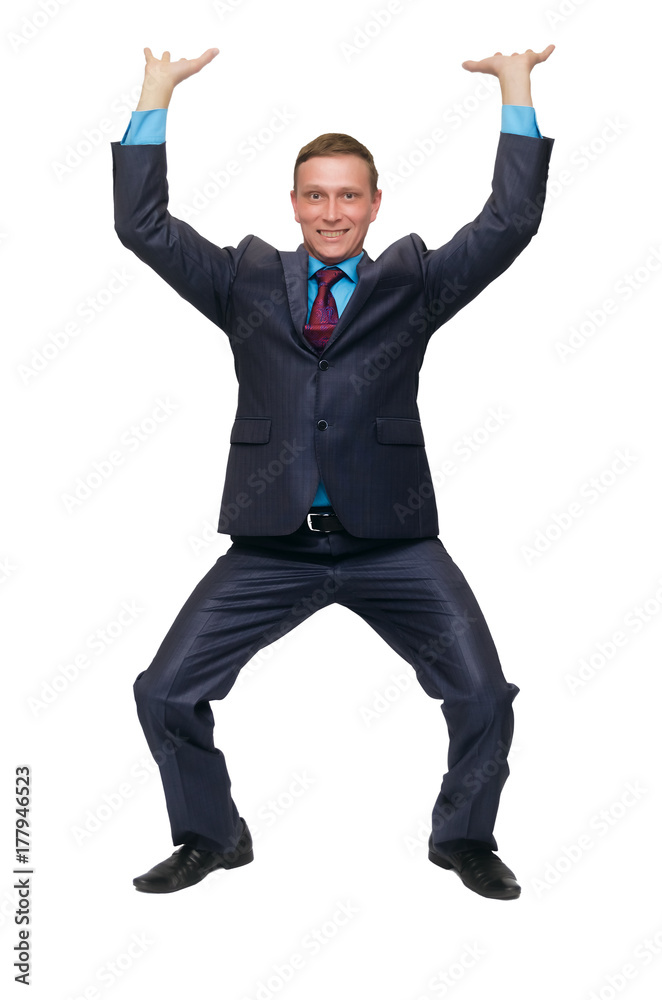 A young business man stands on bent knees and holds his hands above his head as if he is carrying something or holding it, isolated on white background. A young business man stands on bent knees and holds his hands above his head as if he is carrying something or holding it, isolated on white background.