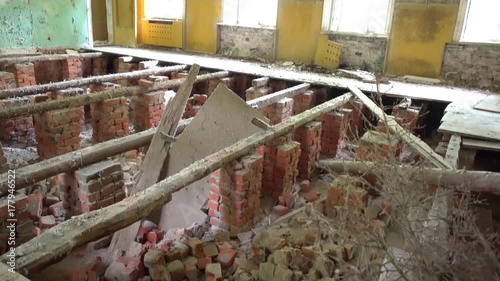 Chernobyl, Ukraine - 17th of June 2017: Visit to Zalesye village in Chernobyl zone - 4K Collapsed floor in the building of cultural center photo