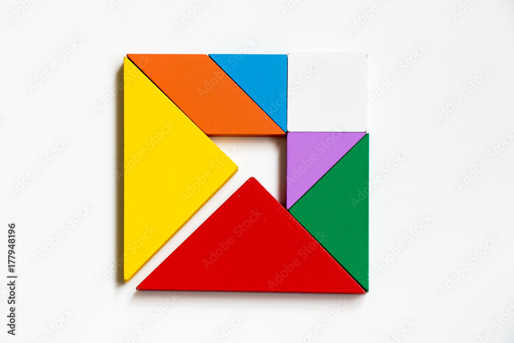 Colorwood tangram puzzle on square with arrow sign shape on white background (Concept of Business direction, company vision or target) Colorwood tangram puzzle on square with arrow sign shape on white background (Concept of Business direction, company vision or target)