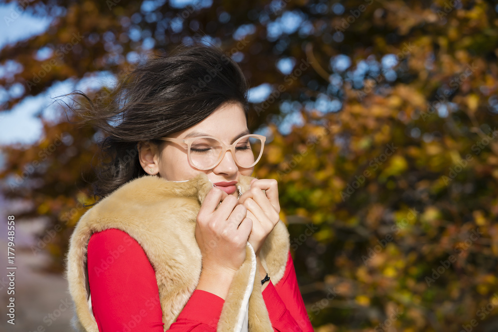 Beautiful young brunette enjoys a sunny day of autumn in nature Beautiful young brunette enjoys a sunny day of autumn in nature