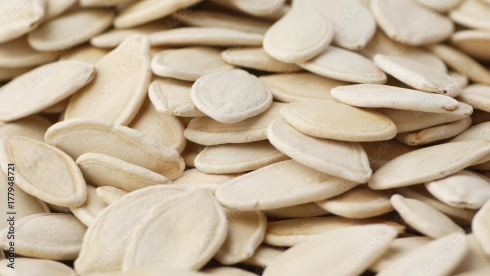Pumpkin seeds macro closeup revolving on a turntable. Salty organic and healthy pumpkin seeds rotating. Not loopable. Pumpkin seeds macro closeup revolving on a turntable. Salty organic and healthy pumpkin seeds rotating. Not loopable.
