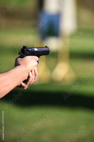 Outdoor shooting with a 9mm pistol in a shooting range
