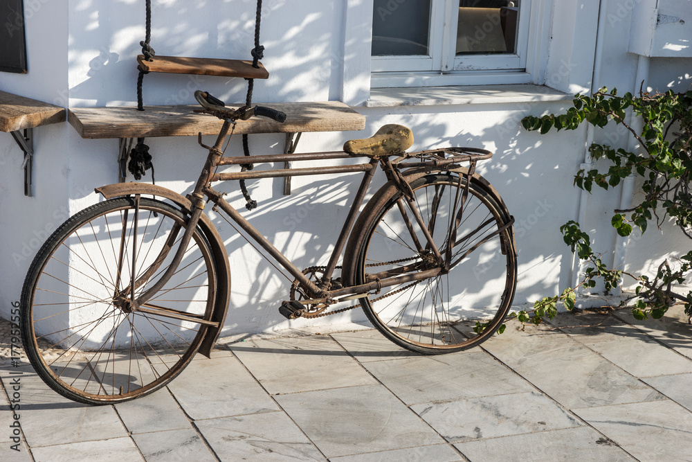 Altes Fahrrad lehnt an weißer Wand