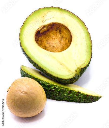 Avocado (Persea americana, alligator pear) slices with a stone isolated on white background photo