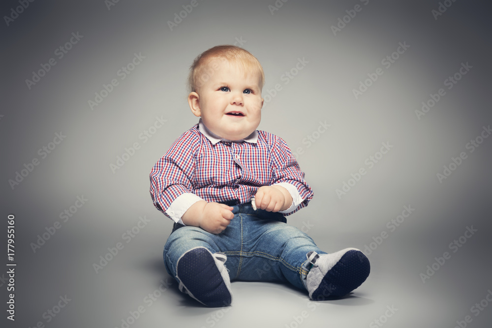 Little child sitting on the floor, smiling. Little child sitting on the floor, smiling.