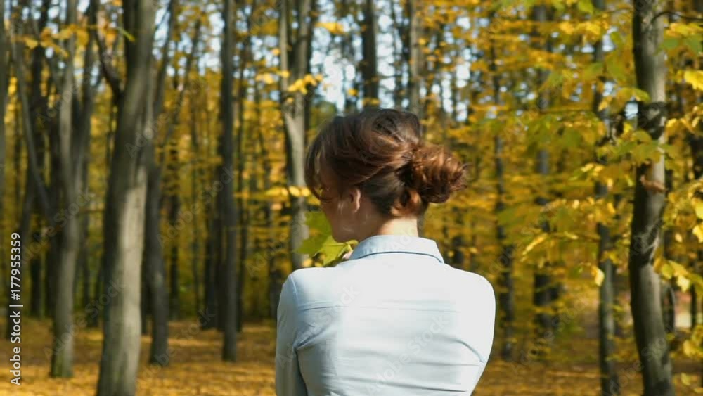 Elegant woman walking in a park Elegant woman walking in a park