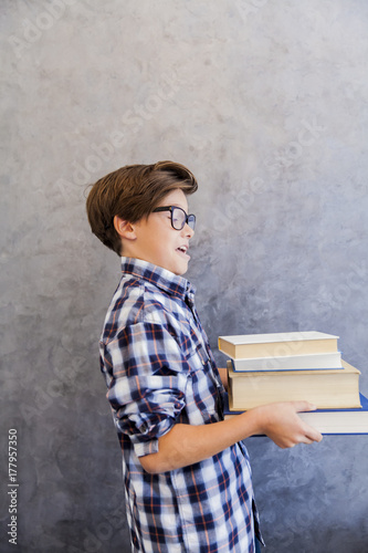 Cute teenage school boy hol...