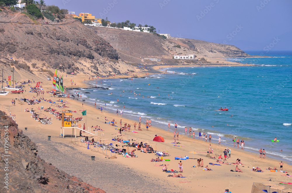 people rest on the beach