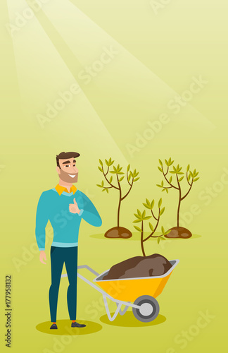 Caucasian gardener with wheelbarrow standing on the background of newly planted trees. Hipster gardener pushing wheelbarrow with tree and dirt in park. Vector flat design illustration. Vertical layout