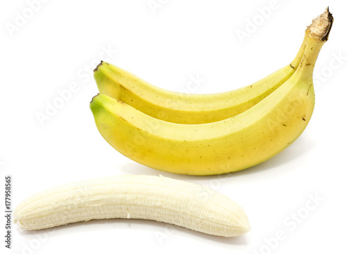 Two whole bananas and one peeled banana isolated on white background photo