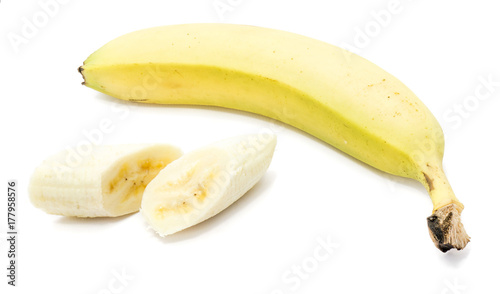 One whole yellow banana and two peeled slices isolated on white background