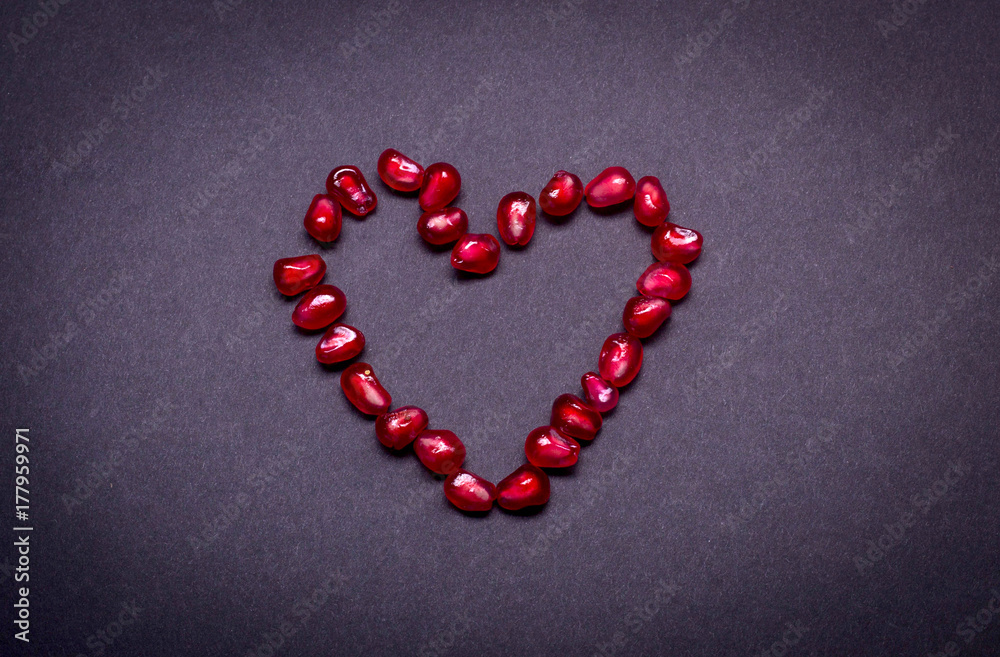 Fresh pomegranate macro picture on isolated black background