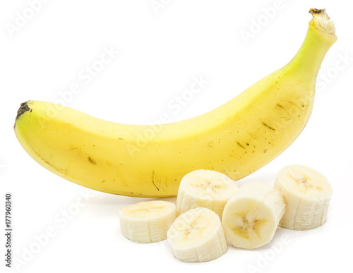 One whole banana and sliced pieces isolated on white background