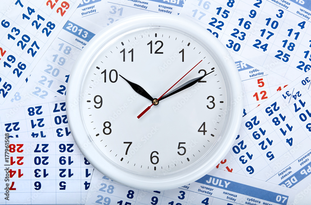 clock with wall calendar sheets with the number of days clock with wall calendar sheets with the number of days