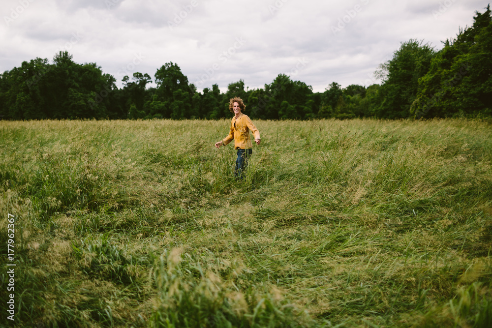 Young boy frolics through pasture Young boy frolics through pasture