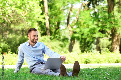 Elegant man with laptop sit...