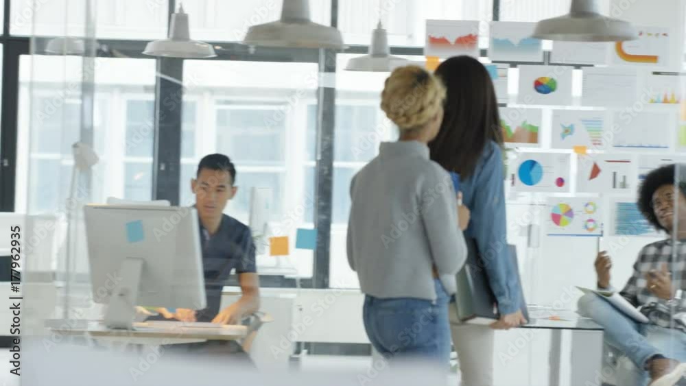 Young casual business group in a meeting in creative office. Shot on RED Epic. Young casual business group in a meeting in creative office. Shot on RED Epic.