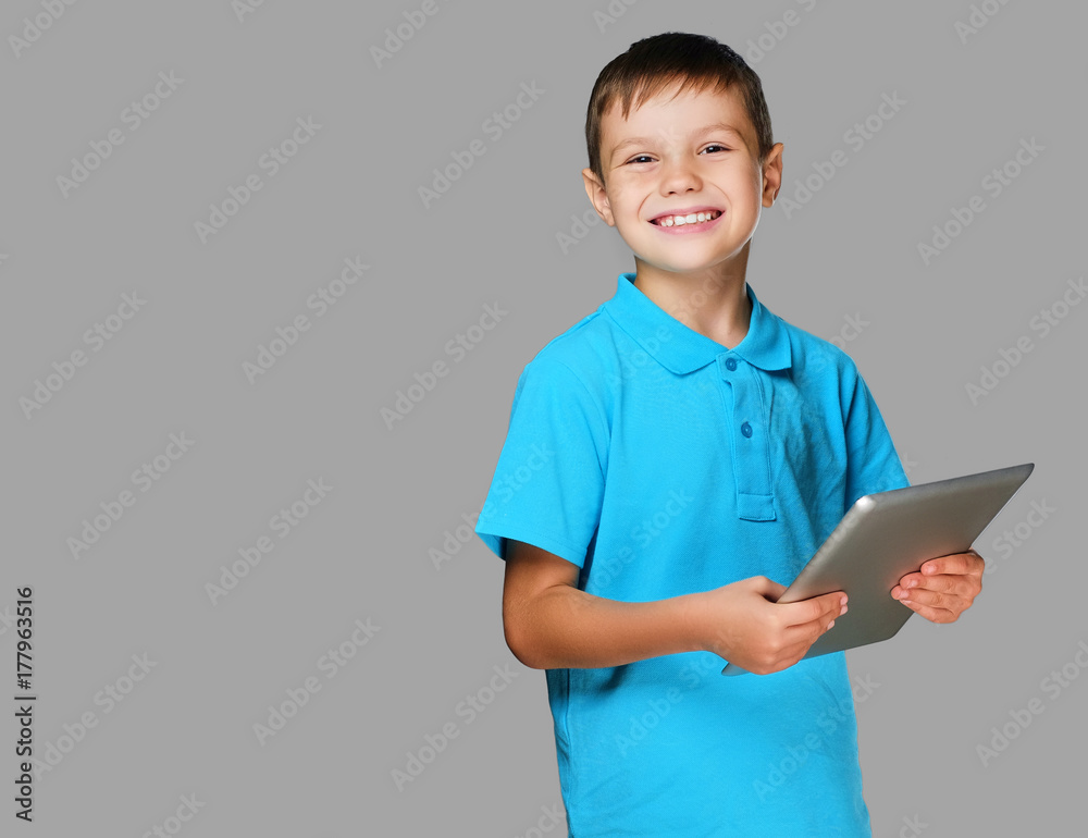 The positive teenager boy holds tablet PC. The positive teenager boy holds tablet PC.