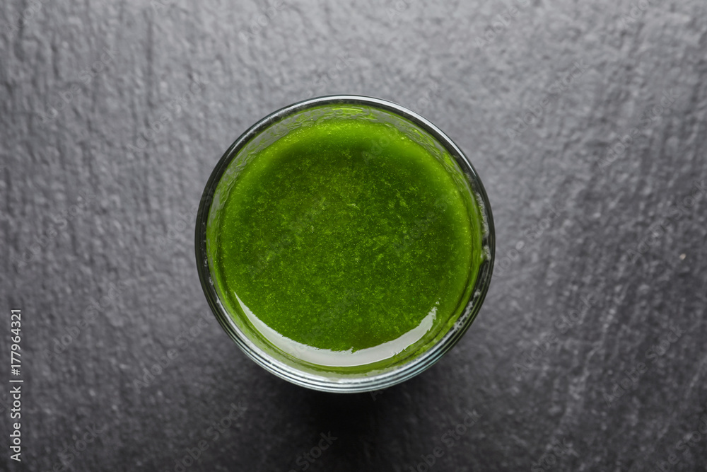 Shot of healthy wheat grass juice on slate plate Shot of healthy wheat grass juice on slate plate