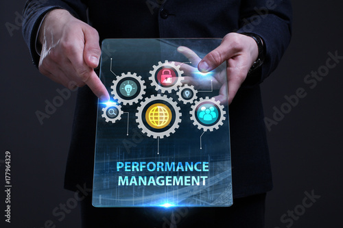 Business, Technology, Internet and network concept. Young businessman working on a virtual screen of the future and sees the inscription: Performance management