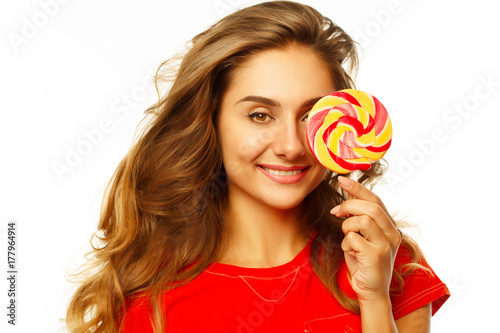 Portrait of a happy pretty girl holding sweet candy over white background © Sunny
