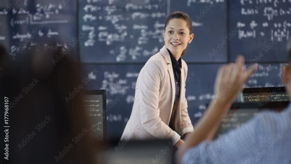 Teacher in adult education class explaining math formulas to students Teacher in adult education class explaining math formulas to students