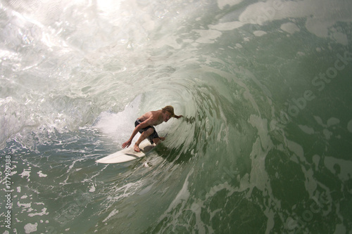 Surfer pulls into tubular wave photo