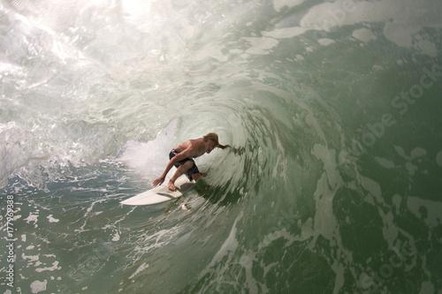 Surfer pulls into tubular wave