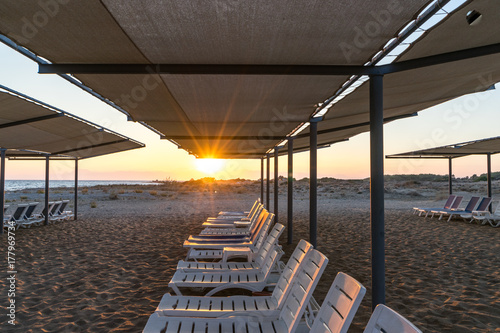 Fototapeta Naklejka Na Ścianę i Meble -  deckchairs by the sea on a sandy beach