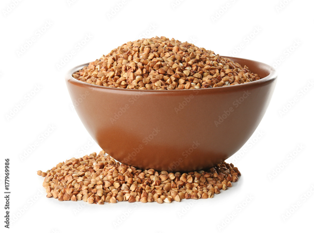 Raw buckwheat and bowl on white background