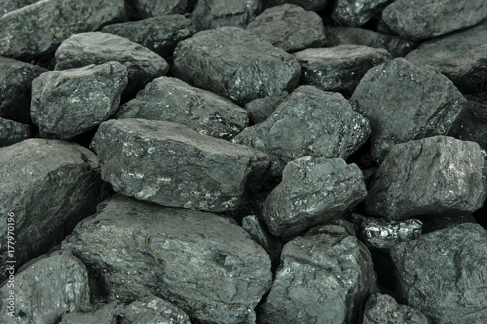 Concept of energy fuel - black coal in close-up as a texture or background