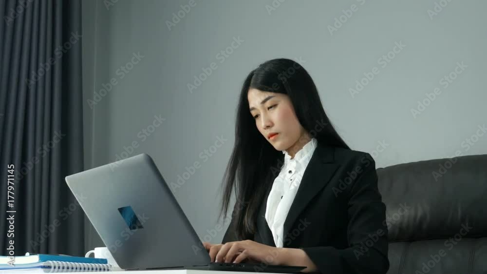 4k of young Asian Business woman working on laptop computer in office. 4k of young Asian Business woman working on laptop computer in office.
