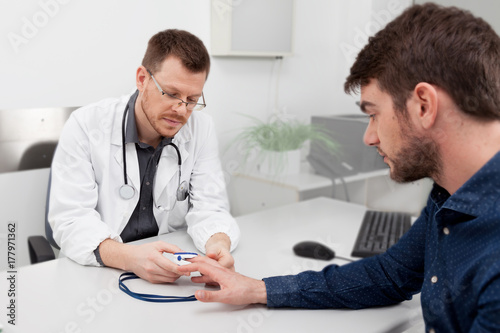 A doctor consulting with a pulse oximeter