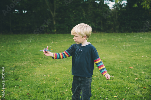 Child playing with a toy aeroplane