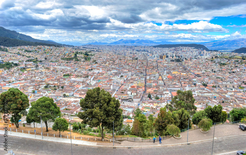 High view of Quito, from the Panecillo hill, on a cloudy and overcast afternoon. Quito, Ecuador.